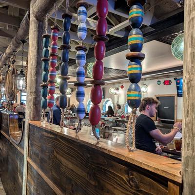 Hand-painted buoys hanging along the wooden bar